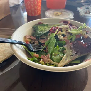 Salad made with spinach, beets, cucumbers, feta cheese and spicy chicken.