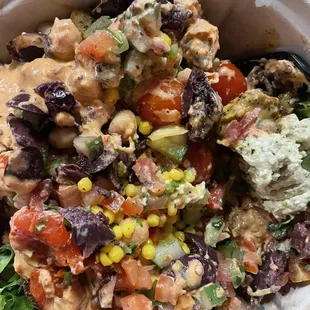 Mixed bowl with hummus, olives, corn, falafel, chicken, etc