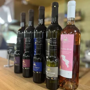 a row of wine bottles on a counter