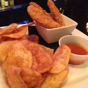 Chicken strips with buffalo sauce and chips. 6 out of 10