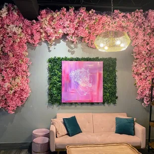 a living room decorated with pink flowers