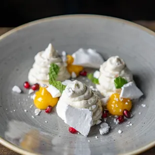 Sweet goat cheese mousse with passionfruit curd, mint, and pomegranate.