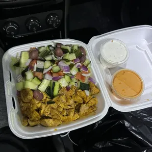 Shawarma chicken, mujadara rice, cucumbers, tomatoes, red onions, feta cheese, kalamata olives, mezze sauce and Tzatziki sauce