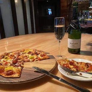 Happy hour. Half off pizzas and bottles of house wines for $12