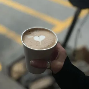 a person holding a cup of coffee