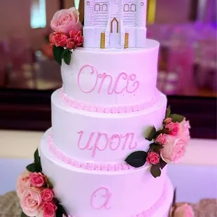 a three tiered cake with a castle on top