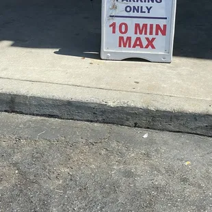 a sign on the sidewalk