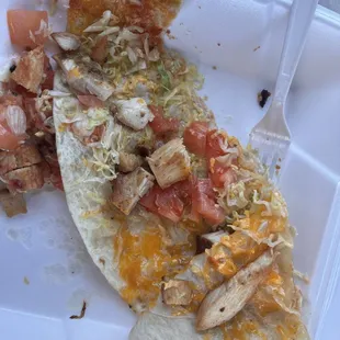 This is supposed to be the chicken quesadilla a few pieces of chunky chicken, shredded lettuce, chunks of tomatoes, shredded cheese SAD