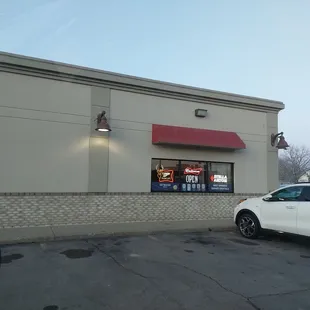 a car parked in front of a restaurant