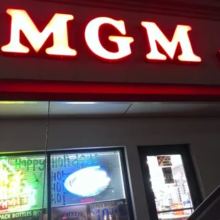 the neon sign for mgm wine and spirits