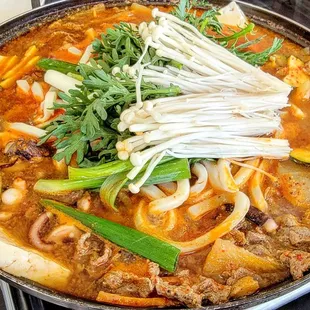 a bowl of stew with noodles and vegetables