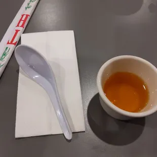 a cup of tea and a spoon on a napkin