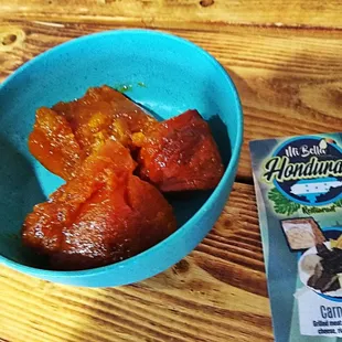 a blue bowl of food and a packet of chips