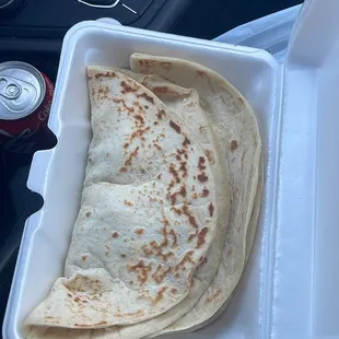 a tortilla in a styrofoam container