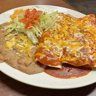 a plate of mexican food and a drink
