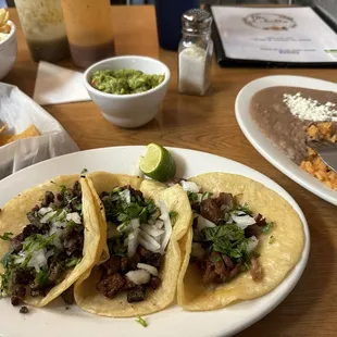 Carnitas taco. Al pastor taco without pineapple (   )  Carne Asada (steak) taco. Rice and beans