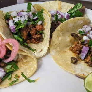 Tacos from left to right: cochinita pibil, al pastor, shredded beef, and diabla