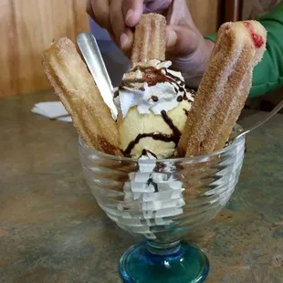 a bowl of ice cream and churros