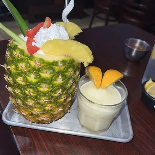 a pineapple with whipped cream and fruit