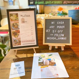 a menu and a sign on a table