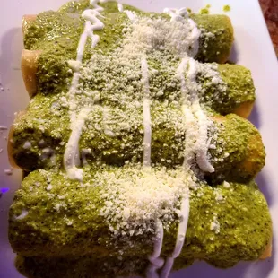 Enchiladas made w/ fresh corn tortillas, stuffed with plenty and tasty shredded chicken, and topped with a delicious green poblano sauce!