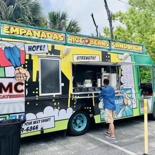 a man standing in front of a food truck