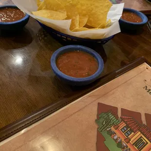 a bowl of chips and a bowl of salsa