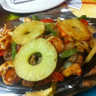 Fajita Cozumel- Steak, chicken, beef, shrimp, chorizo and pineapple with cooked onions, tomatoes and bell peppers.