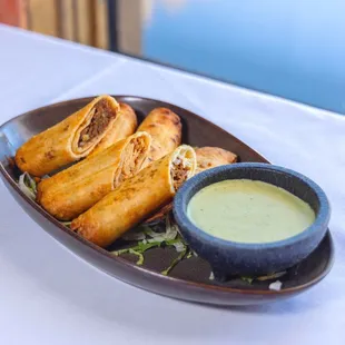 Flautas - crispy rolled flour tortillas, filled with asadero jack cheese, adobo braised short rib, chicken tinga, and carnitas