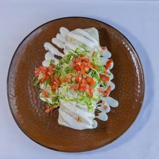 Steak Burrito - ancho grilled steak, oaxacan rice, black beans, guacamole, asadero jack cheese, pico de gallo, crema, lettuce, tomato