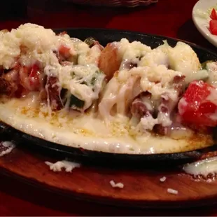 Skewers with seasoned steak, shrimp, peppers and onions, yum.