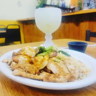 a plate of chicken, broccoli and rice