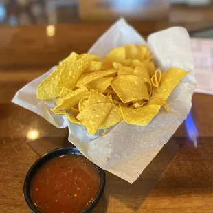 a bowl of chips and a bowl of salsa