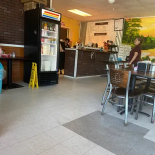 a woman sitting at a table in a restaurant
