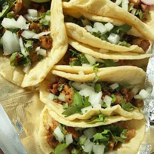 a tray of tacos and pickles