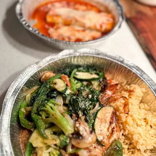 a plate of food with rice and broccoli