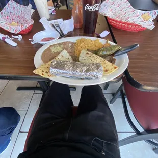a person sitting at a table with a plate of food