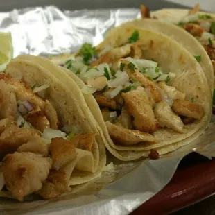 Tacos De Pollo Asada.   Three grilled chicken tacos served with rice and beans.