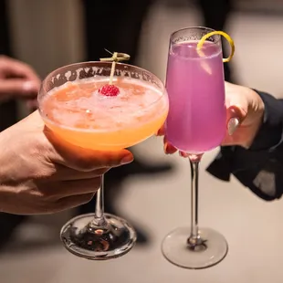 two people toasting with drinks