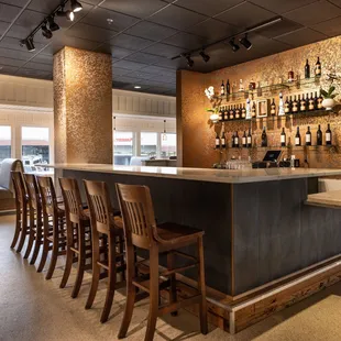 a bar with wooden chairs