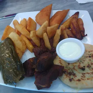 Tamale(chicken),  pupusa (zucchini con queso), Yucca fries w/ frijoles, and pork.