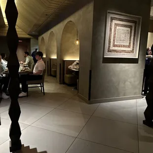 people sitting at tables in a restaurant