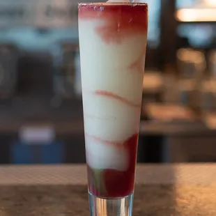 a red and white drink with a straw