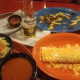 Carne asada fries plate, chips and dip (all gone) bean burrito with red sauce and lettuce on the side plus a 1$ Corona!