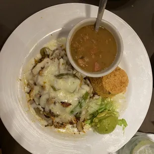 Chicken and chorizo topped with bell peppers, Monterrey cheese, rice, beans