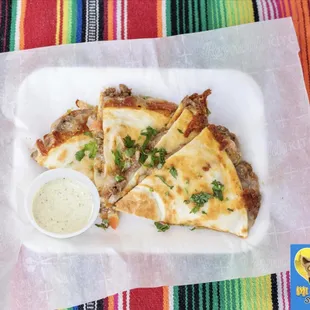 Beef Asada Quesadilla, Monterrey Jack Cheese, Pico de gallo with a side of roasted poblano crema.