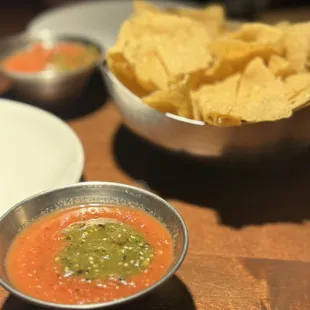 a bowl of salsa and a bowl of tortillas