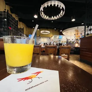 Indoor dining area with mango margarita.