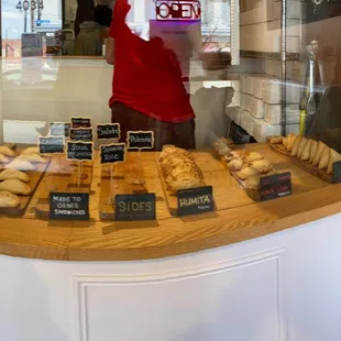 a man standing in front of a bakery