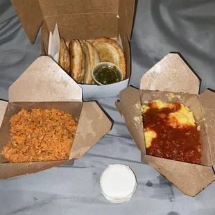 three boxes of food on a bed